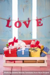 Gifts in a crate and the word love as a banner 4ZM8N5