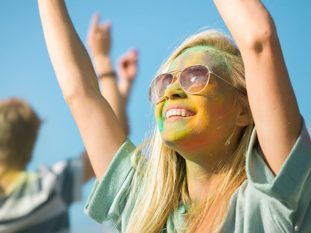 Woman's Face and Clothes are Covered with Colorful Powder in Indian Festival