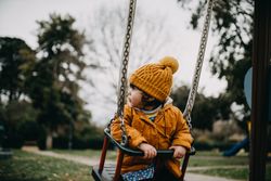 Little girl in swing at the park