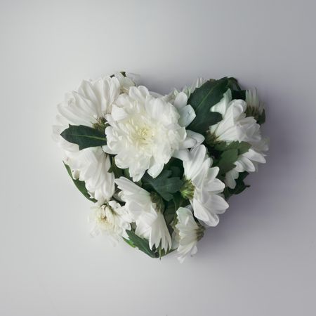 Flowers in shape of a heart on light  background