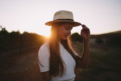 Portrait of a young woman in a hat outdoors