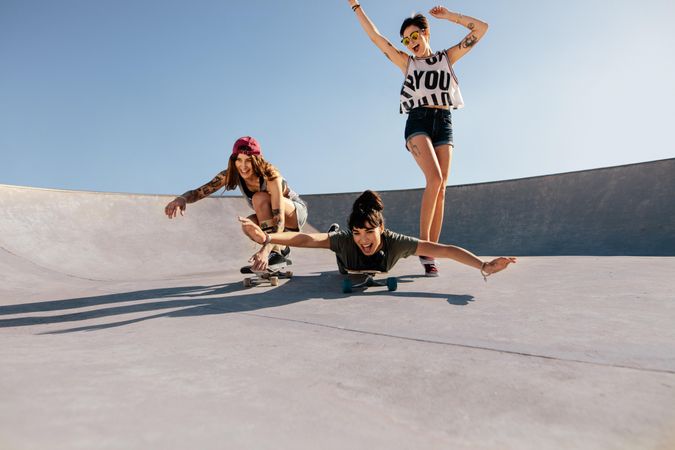 Group of women playing with skateboards outdoors