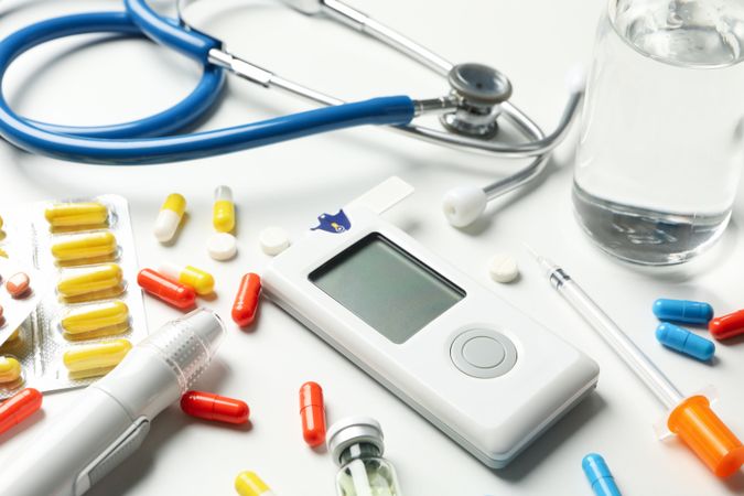 Diabetes accessories on blank background, close up