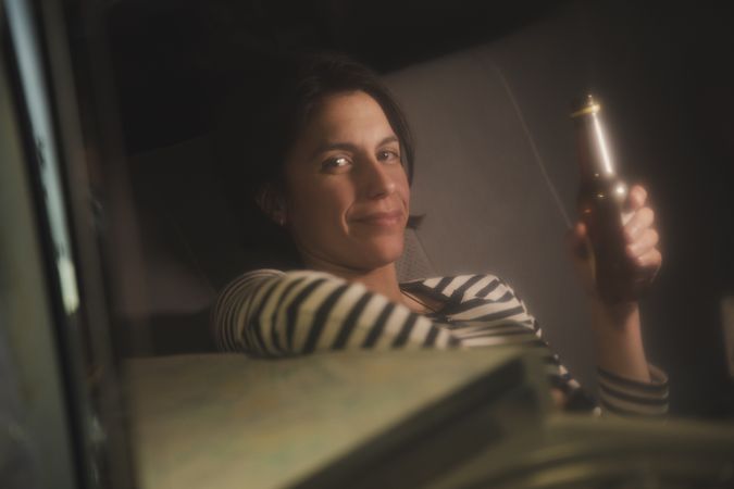 Reflection of woman drinking from bottle