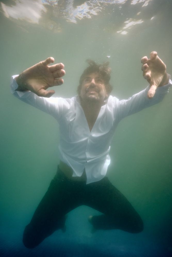 Man drowning in deep water in pool