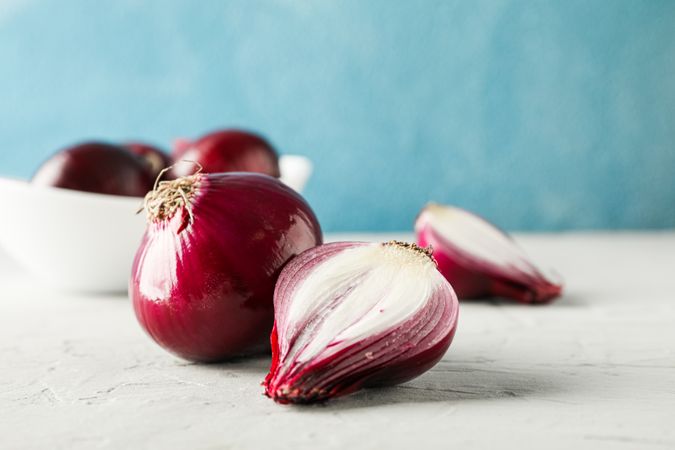 Flat lay composition with red onion on light background, space for text