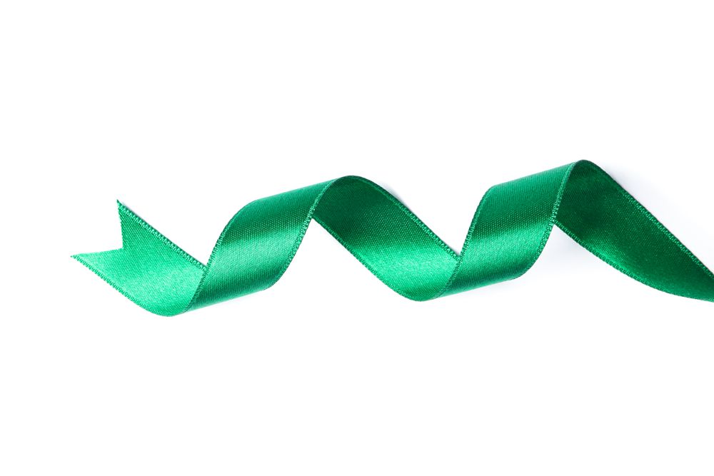 Green ribbon isolated on plain background. Gift concept