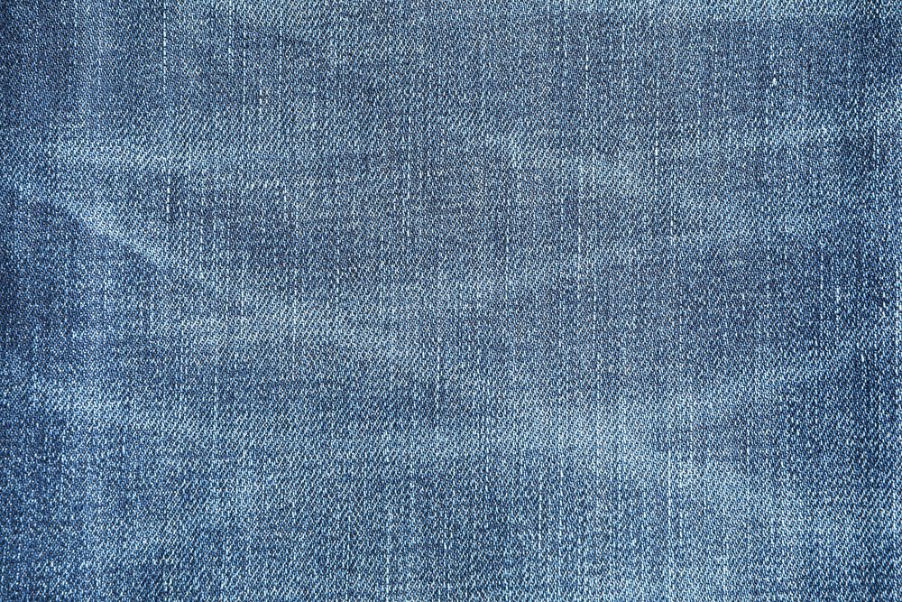 Texture of blue jeans as background, space for text