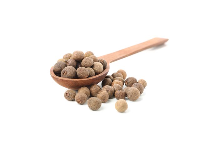 Loose peppercorns with wooden spoon