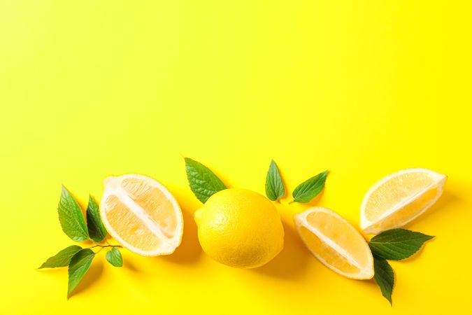 Flat lay composition with lemons on color background, space for text