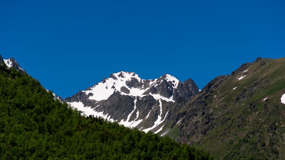 Mountainous landscape with snow patches