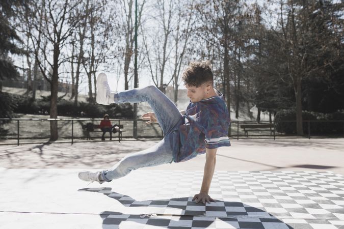 Man dancing break dance in park
