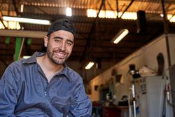Man in uniform sitting in workshop