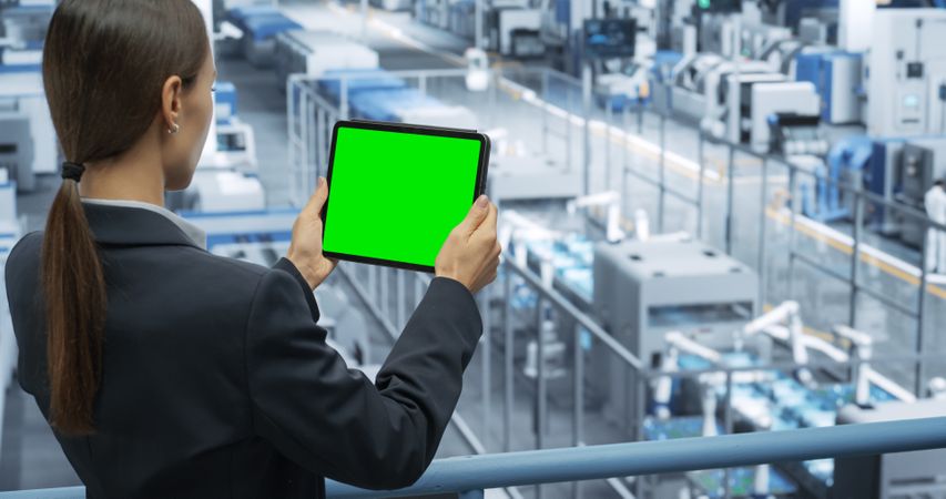 Electronics Manufacturing Project Manager Working on a Tablet Computer with Green Screen Template at a Factory. Female Specialist Developing, Maintaining, Upgrading Programs for Machine Production