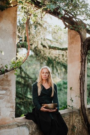 Romantic woman with musical bowl in castle