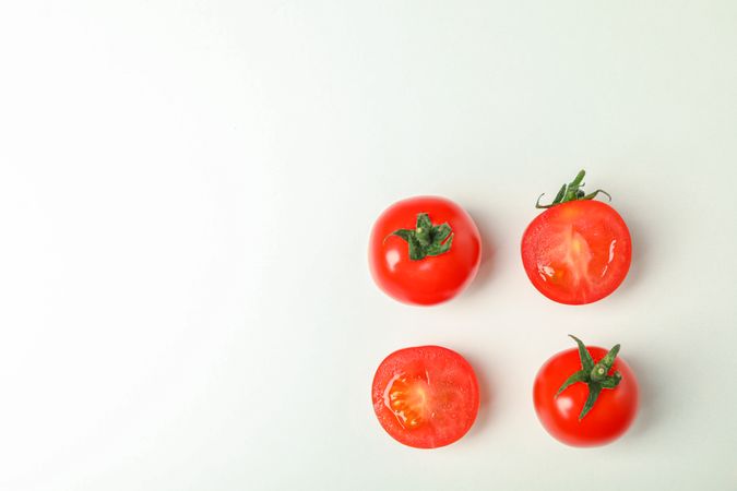 Flat lay composition with fresh cherry tomatoes on plain background, space for text. Ripe vegetables