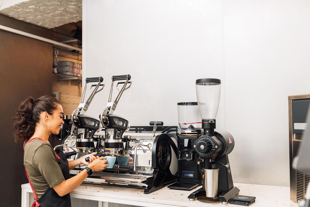 Woman in apron preparing coffee