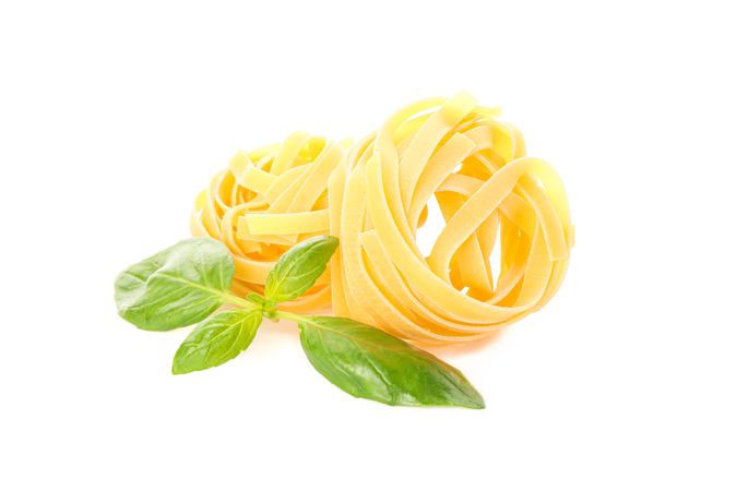 Pasta isolated on bright background. Uncooked whole wheat pasta