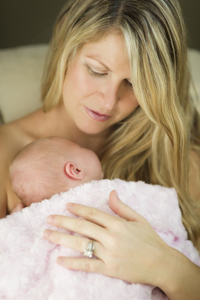 Mother Holding Her Precious Newborn Baby Girl