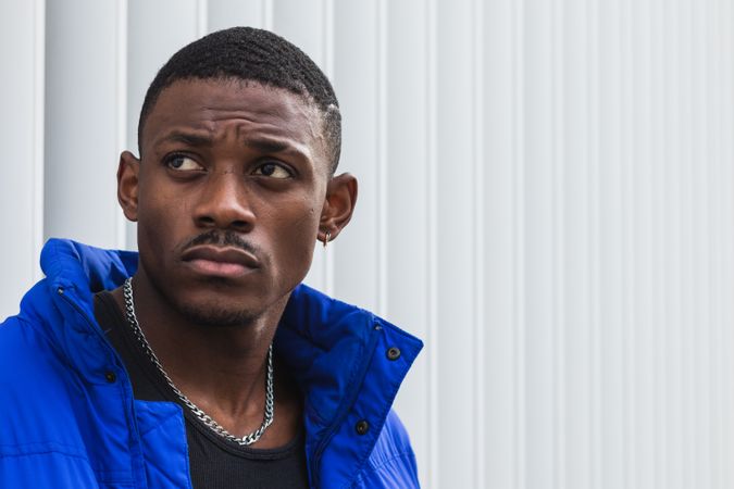 Black stylish man in warm jacket on street