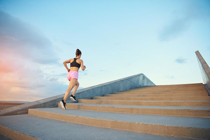 Woman exercising by running up stairs