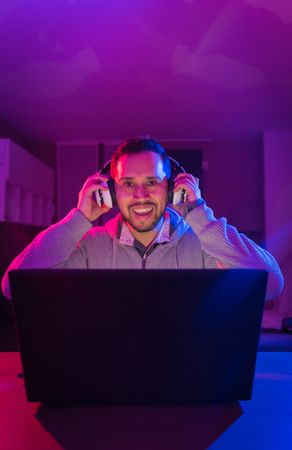 Man listening cheerfully to music with headphones.