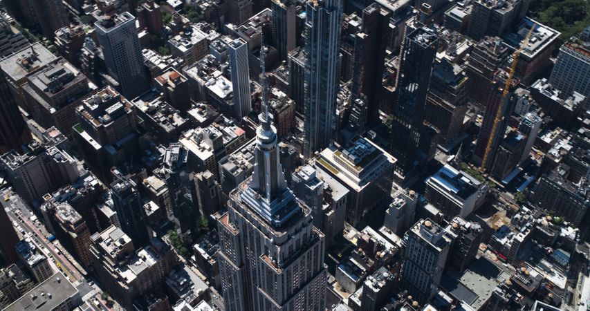 Aerial Footage of New York City and Manhattan Panoramic Skyline with Iconic Empire State Building. Helicopter View of the Cityscape from Above with Towering Tourist Attraction