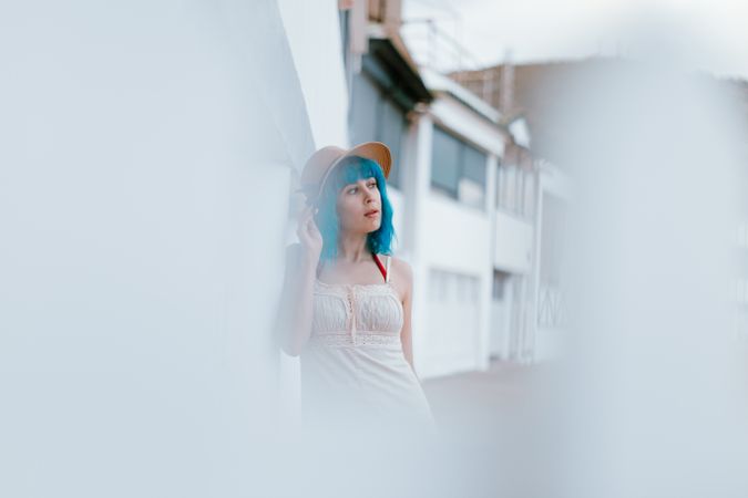 Carefree woman in sundress walking along sunny street