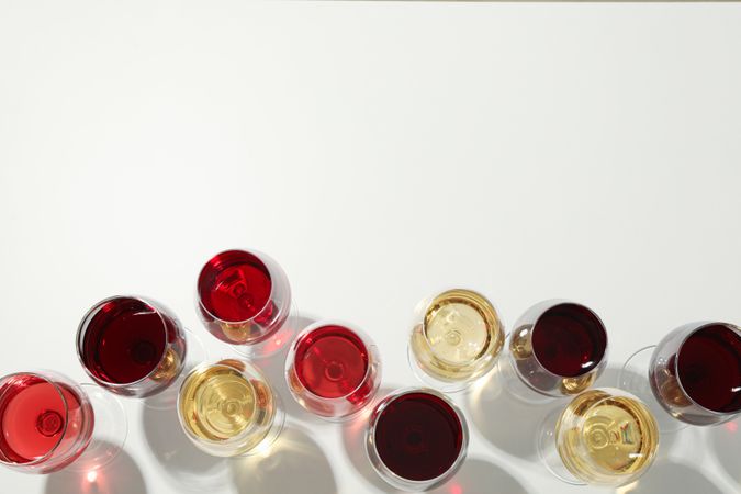Flat lay composition. Glasses with different wine on plain background, top view