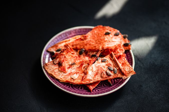 Plate of thin slices of dried watermelon