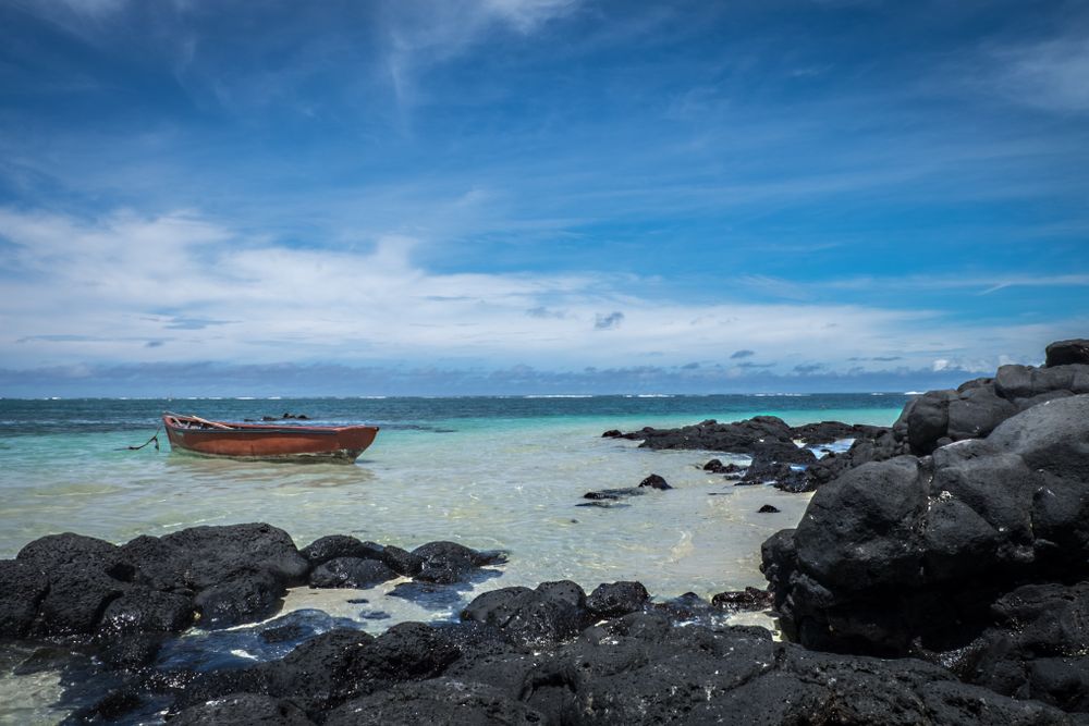 Red boat in shallow tropical lagoon