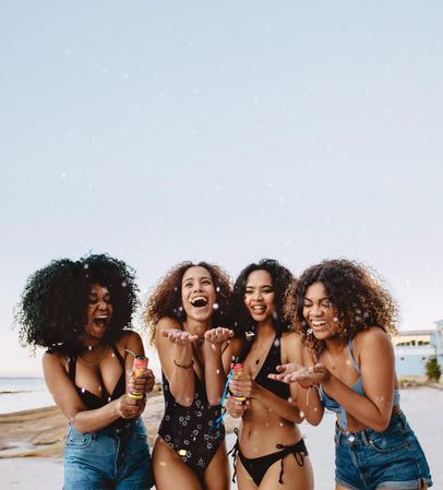 Group of beautiful friends in bikinis enjoying the beach