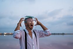 Distressed man with fish tank on head screaming