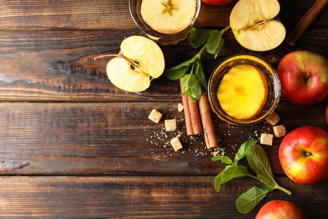 Composition with cider, sugar, cinnamon and apples on wooden table