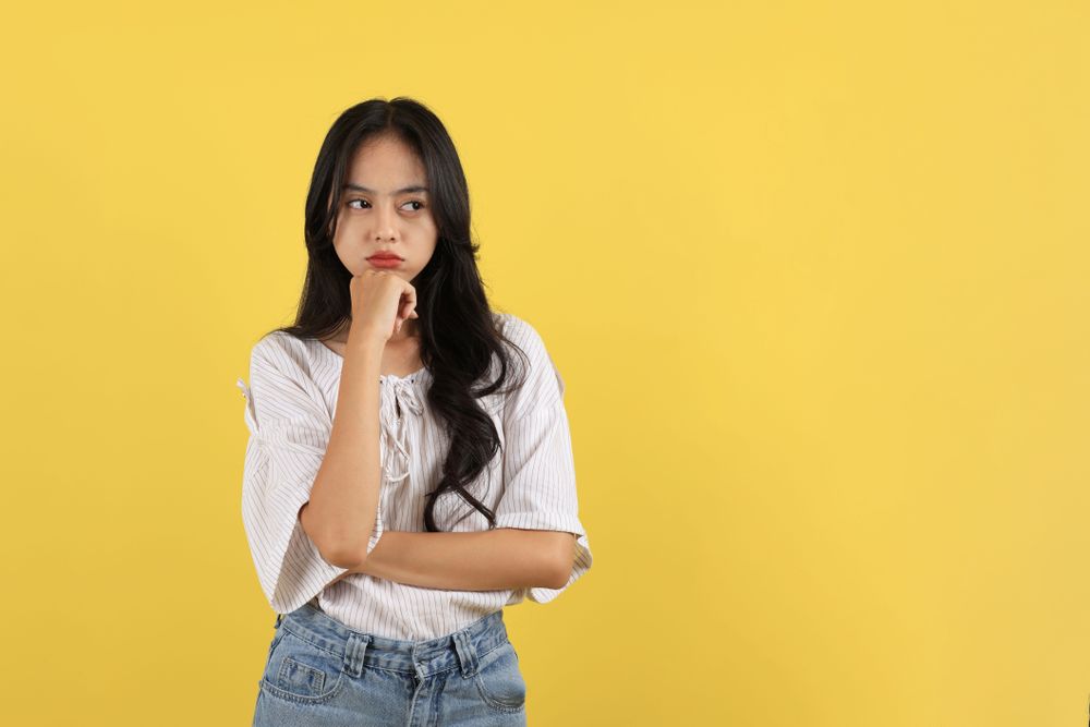Young Asian Teen Girl Pouting Mouth, Bad mood and Unhappy.
