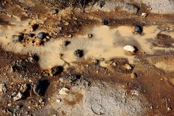 Dirty clay water with rocks