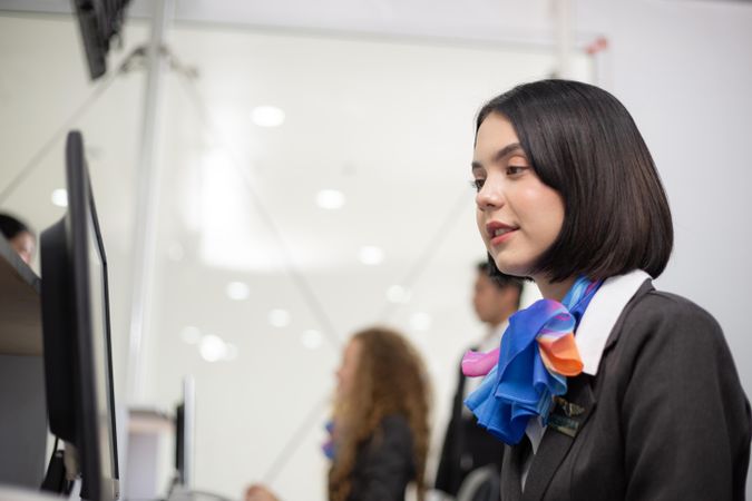 Woman in silk scarf flight attendant uniform working in airport