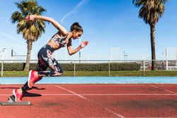 Fit woman running on stadium