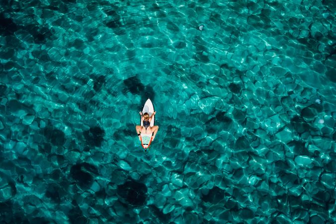 Aerial view with surfer woman on surfboard