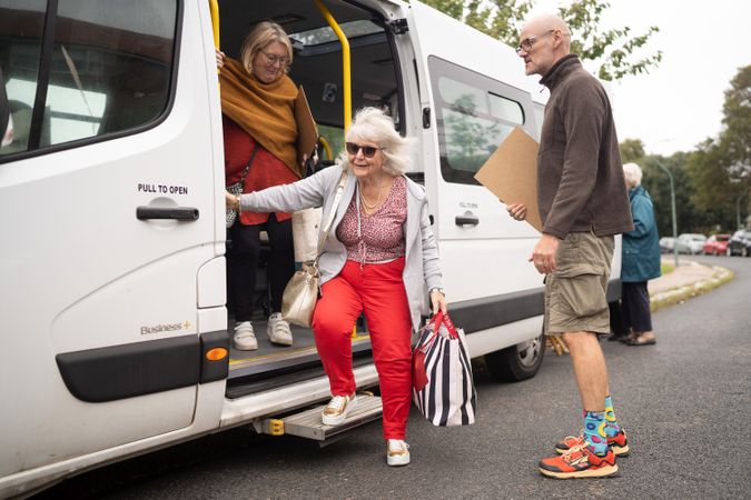 Woman exiting bus for art class