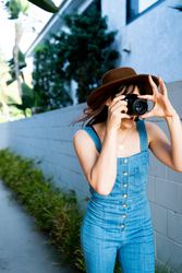 Female photographer taking a picture outside