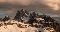 Sharp peaks of rocky mountains against cloudy sky