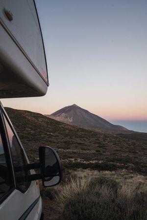 Camper car against remote mountain