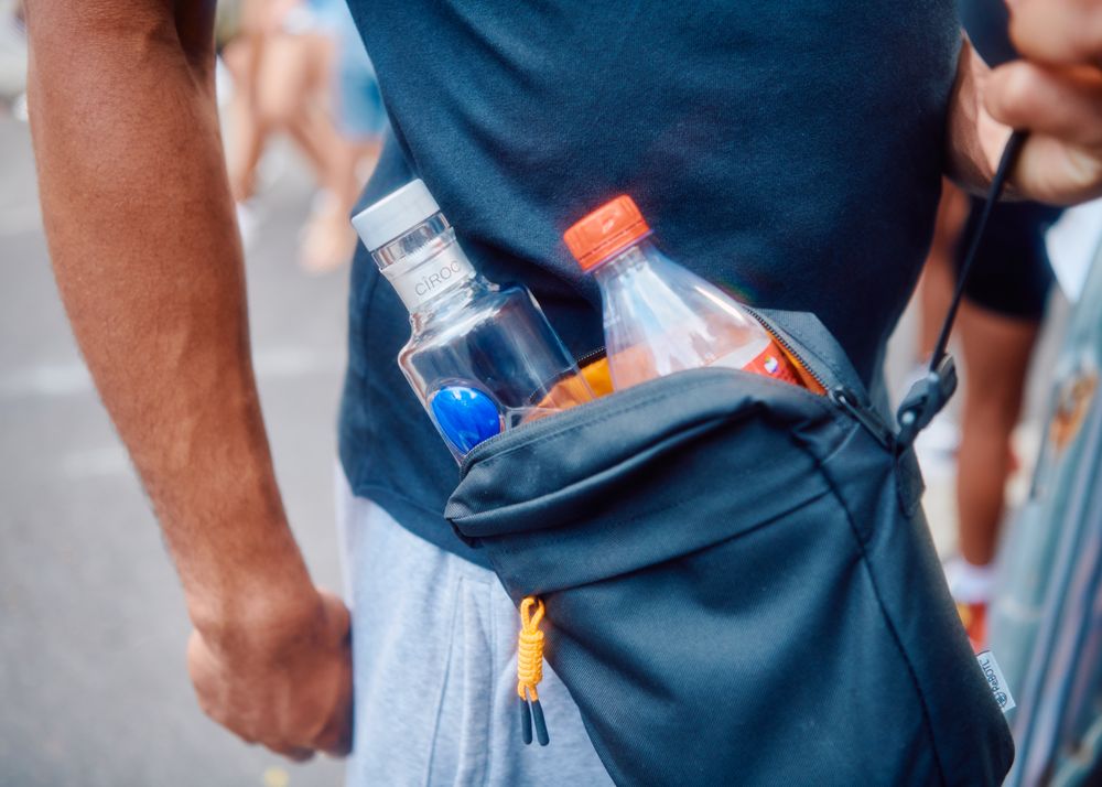 Small bag on man’s body with alcohol for street party