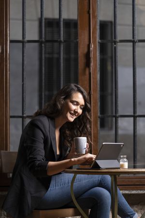 Young female using digital tablet in cafe