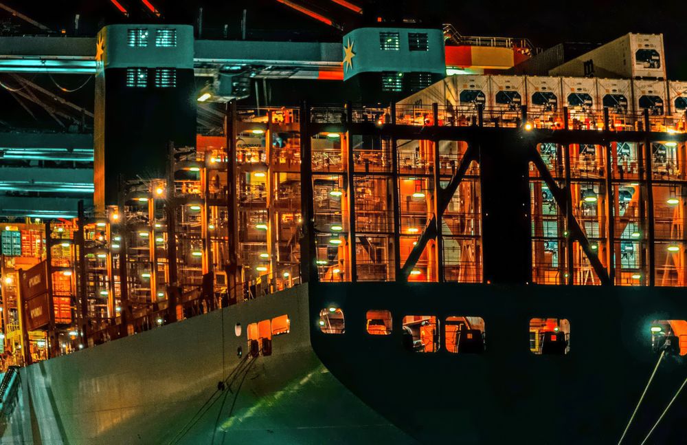 Bustling Container Port at Night Illuminated by Artificial Lights