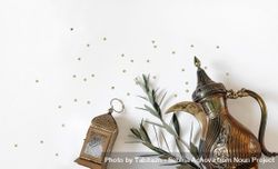 Arabic dallah coffee pot, golden ornamental Moroccan lantern and green olive tree branches 5orGg0