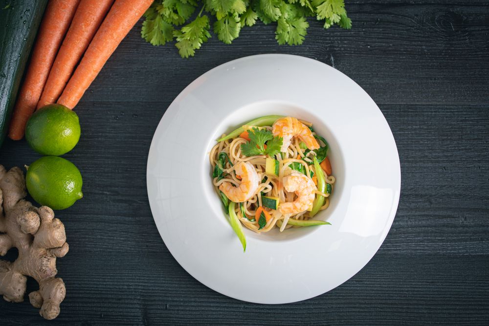 Tasty Pad Thai of vegetables and prawns in plate
