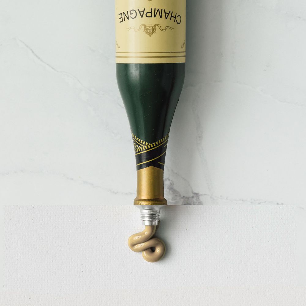 Collage made out of champagne bottle and paint tube