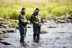 Two Fishermen Laughing in River